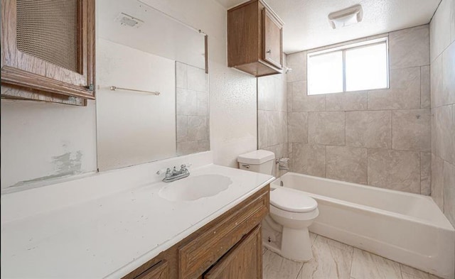 full bathroom with tiled shower / bath, vanity, and toilet