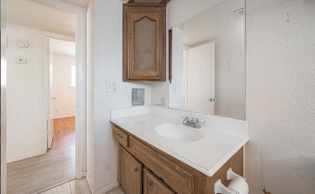 bathroom with vanity and hardwood / wood-style flooring