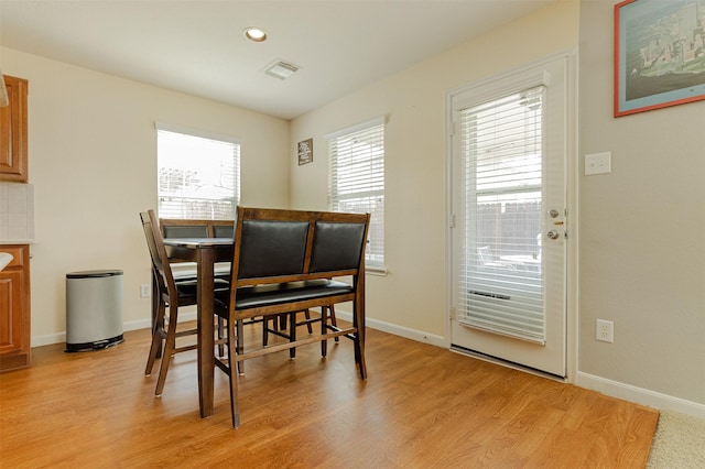 dining space with light wood-type flooring