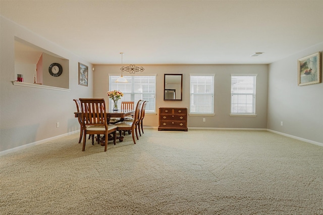 carpeted dining space with a wealth of natural light