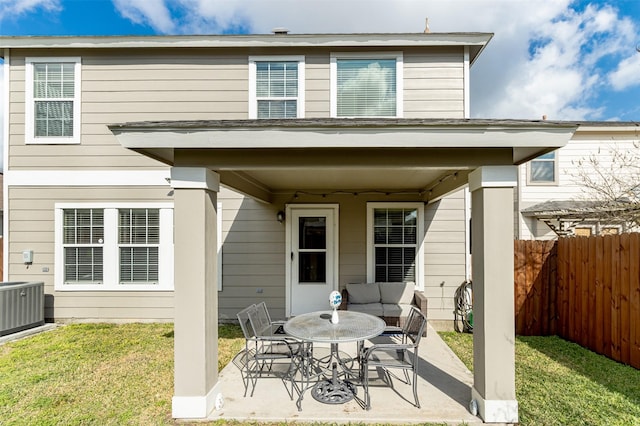 back of property featuring central AC, a patio area, and a lawn