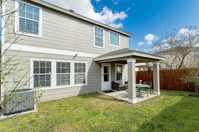 back of property featuring a lawn, a patio area, and central air condition unit