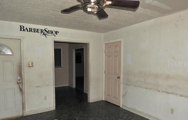 entrance foyer with ceiling fan and a textured ceiling