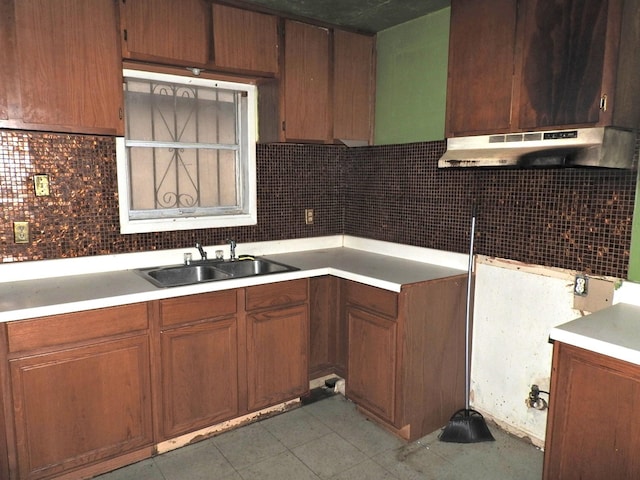 kitchen featuring sink, light tile patterned floors, and decorative backsplash