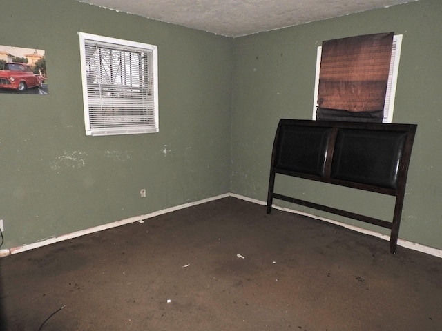 unfurnished room with a textured ceiling