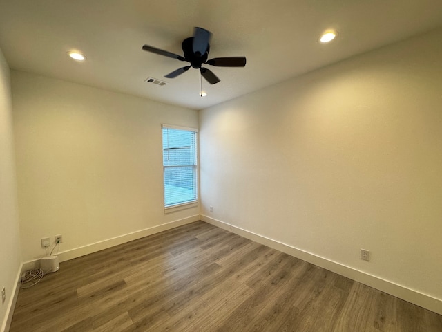 unfurnished room with hardwood / wood-style flooring and ceiling fan