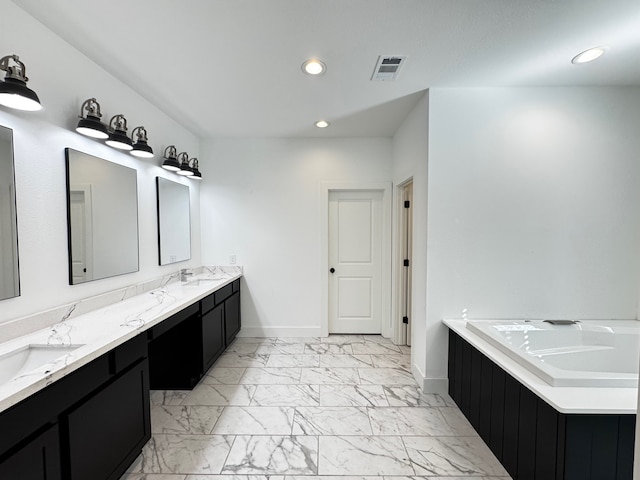 bathroom featuring vanity and a tub