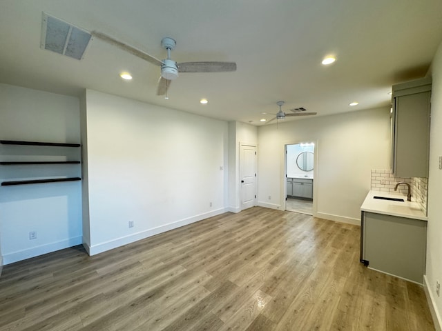 unfurnished living room featuring light hardwood / wood-style floors and ceiling fan