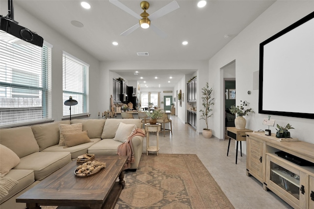 tiled living room featuring ceiling fan