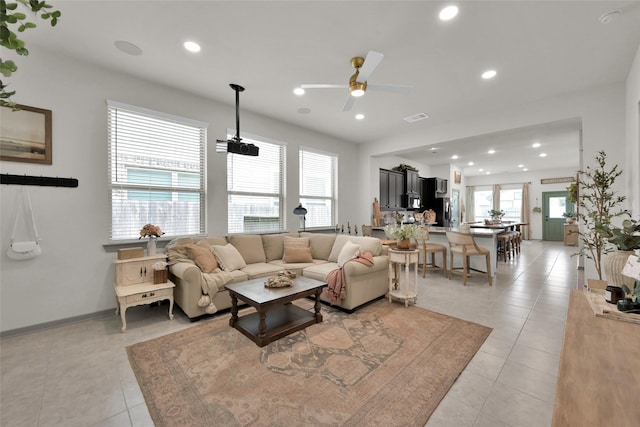 living room with light tile patterned floors and ceiling fan