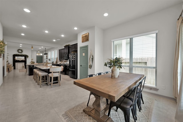 dining room featuring ceiling fan and a healthy amount of sunlight