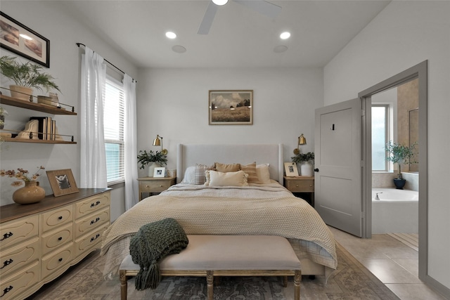 tiled bedroom featuring ceiling fan and ensuite bath