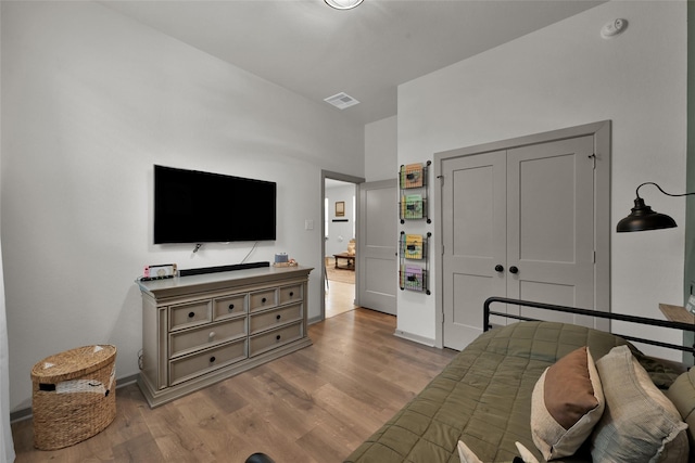 bedroom featuring light hardwood / wood-style floors and a closet