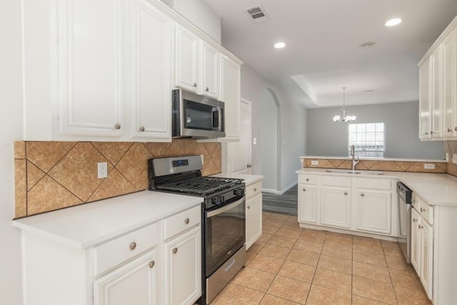 kitchen with white cabinetry, kitchen peninsula, and appliances with stainless steel finishes