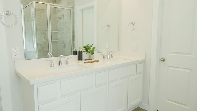 bathroom with vanity and a shower with shower door