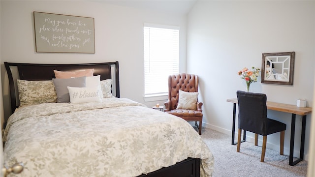 carpeted bedroom with lofted ceiling