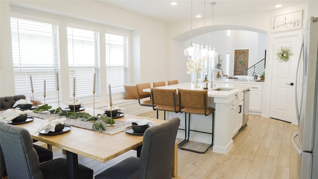 dining room with sink and light hardwood / wood-style flooring