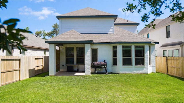 rear view of house featuring a patio and a yard