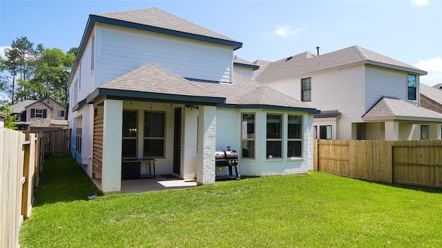 rear view of property featuring a patio and a lawn