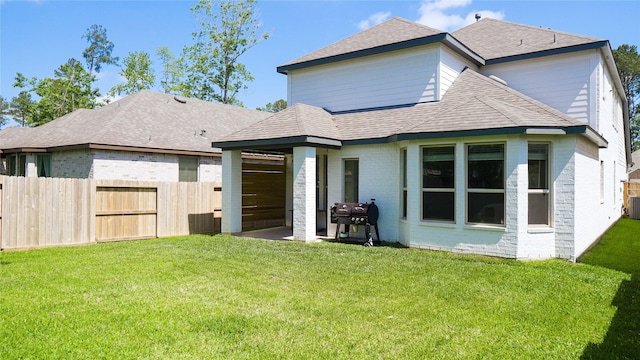 back of house with a patio, a yard, and central AC unit