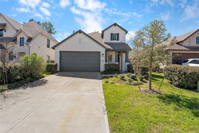 view of front of house with an attached garage, driveway, and a front yard