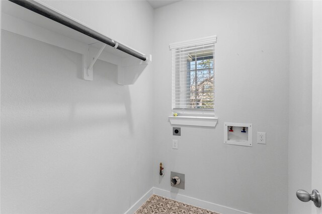 laundry area featuring hookup for a washing machine, baseboards, laundry area, electric dryer hookup, and hookup for a gas dryer