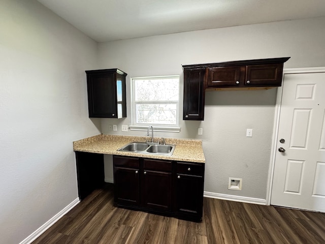 kitchen with sink, dark wood-type flooring, and dark brown cabinetry