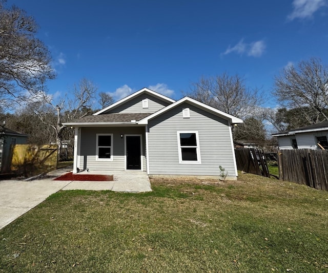 view of front of house with a patio and a front lawn