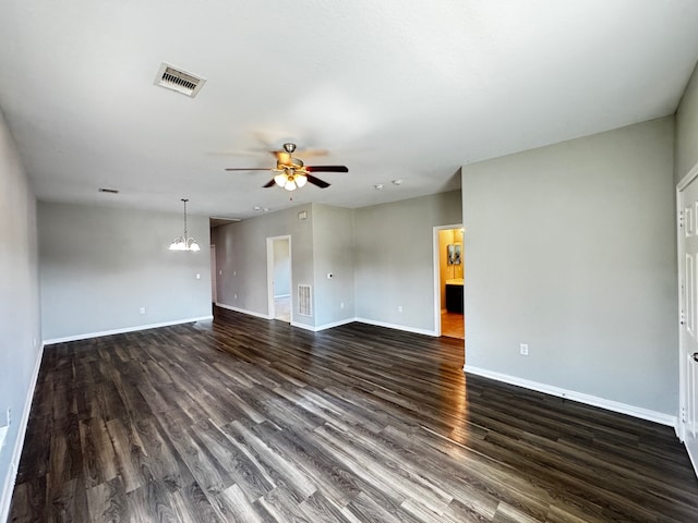 unfurnished room with dark hardwood / wood-style flooring and ceiling fan with notable chandelier