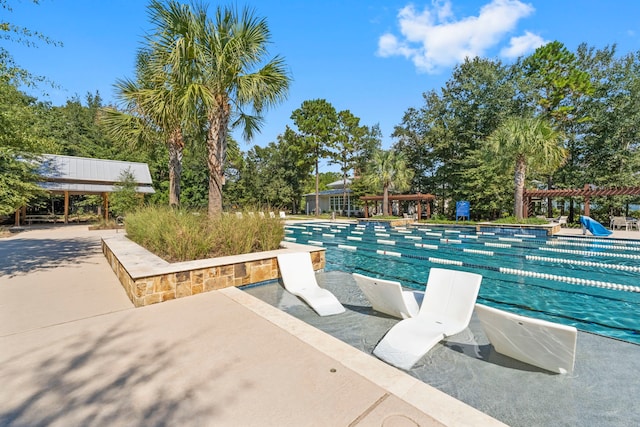 view of pool with a pool and a pergola