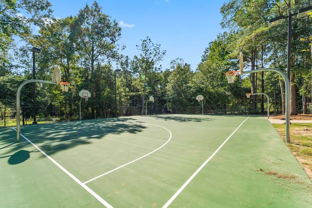 view of basketball court featuring community basketball court and fence