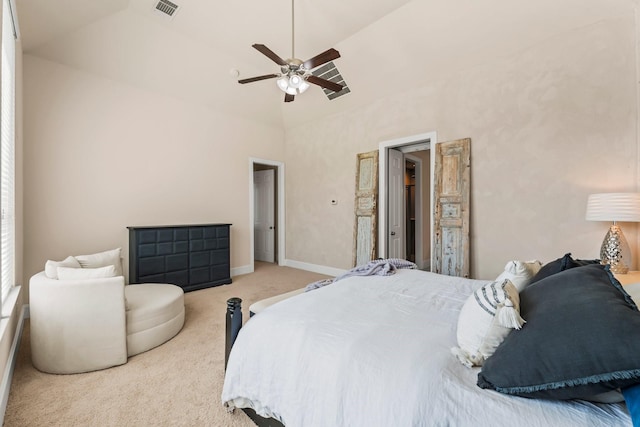 carpeted bedroom featuring lofted ceiling, a ceiling fan, visible vents, and baseboards