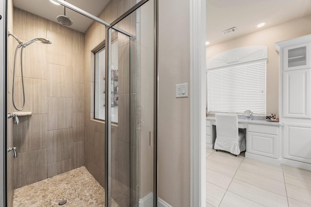 bathroom with visible vents, a shower stall, and tile patterned floors