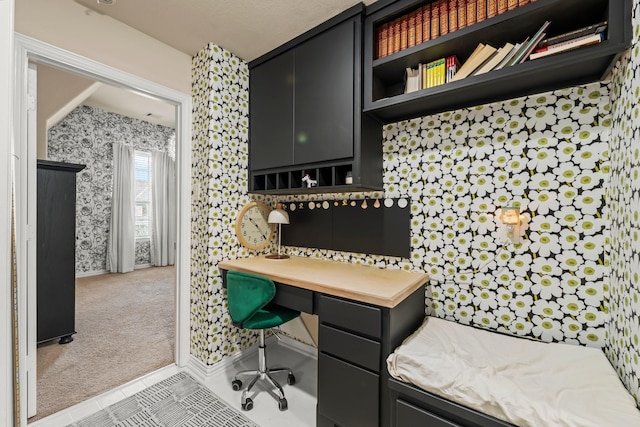 carpeted office space featuring tile patterned flooring and wallpapered walls