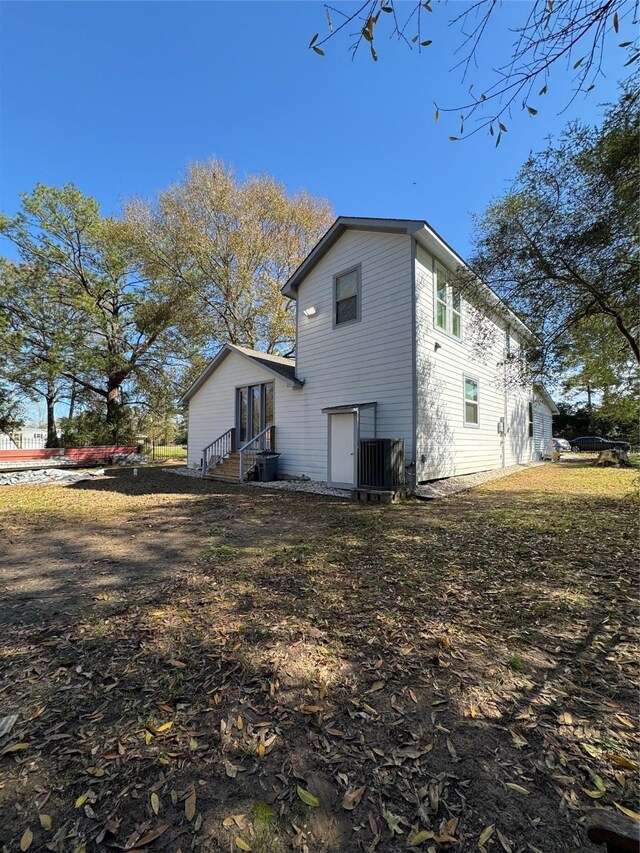 view of side of home featuring cooling unit