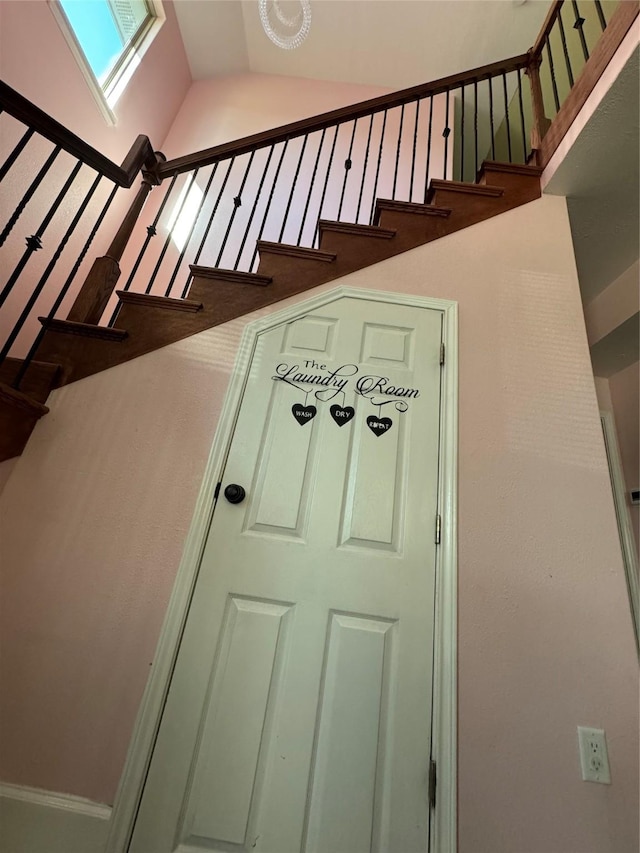 stairs with lofted ceiling