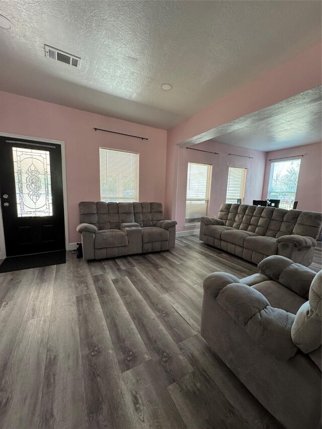 living room with hardwood / wood-style flooring and a textured ceiling