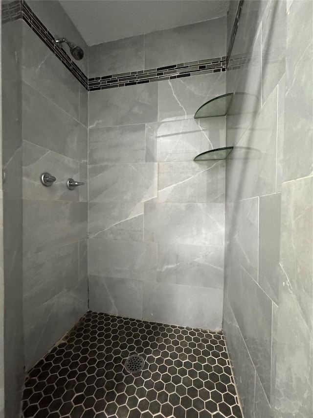 bathroom with tiled shower