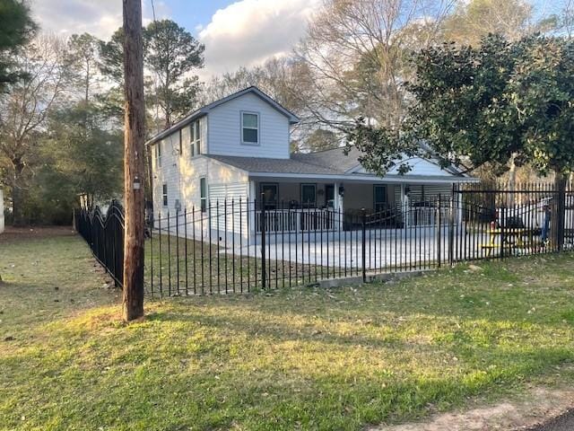 view of front of house featuring a fenced backyard, a front lawn, and a patio area