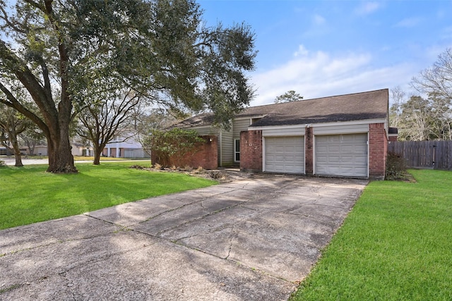 ranch-style home featuring a garage and a front lawn