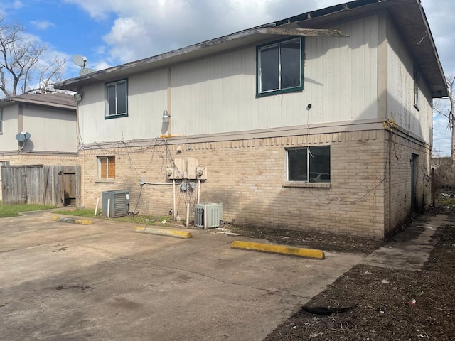 view of property exterior with a patio and central air condition unit