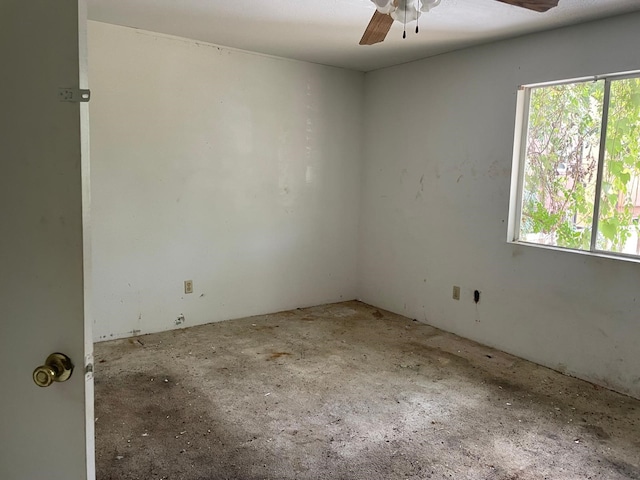 empty room with a wealth of natural light and ceiling fan