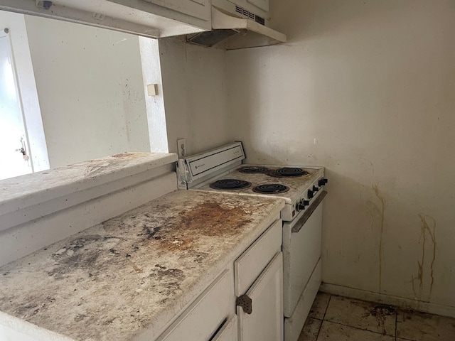 kitchen with white cabinetry and white range with electric stovetop