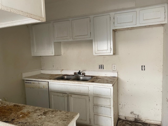 kitchen featuring sink, white cabinets, and dishwasher