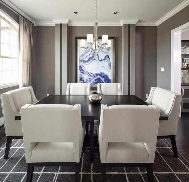 dining room featuring ornamental molding, dark hardwood / wood-style flooring, and a notable chandelier