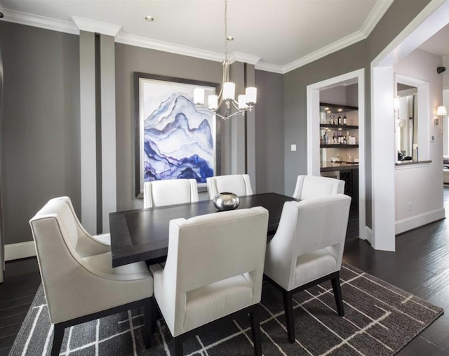 dining space with dark hardwood / wood-style flooring, crown molding, a chandelier, and bar area