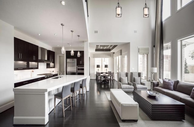 interior space featuring sink, dark hardwood / wood-style flooring, and a towering ceiling