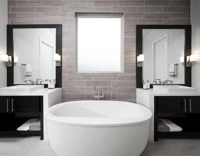 bathroom with tile walls, vanity, tile patterned flooring, and plenty of natural light