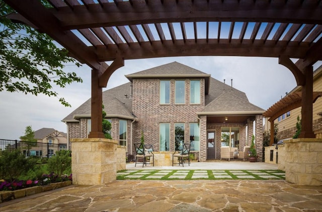 rear view of house with a pergola and a patio area