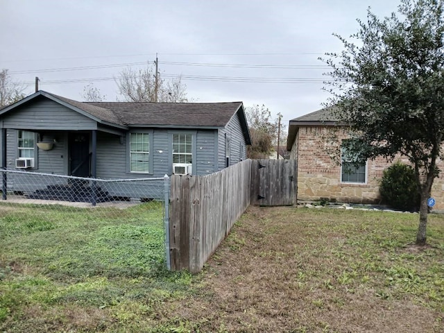 view of front of home with cooling unit and a front lawn